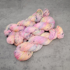 Desert Rainbow - Hand Dyed DK Weight Superwash Merino Wool and Silk Yarn, UV Reactive Pastel Rainbow Black Speckle, 245 Yards (224 Meters)