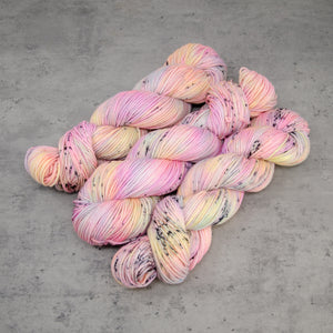 Desert Rainbow - Hand Dyed DK Weight Superwash Merino Wool and Silk Yarn, UV Reactive Pastel Rainbow Black Speckle, 245 Yards (224 Meters)