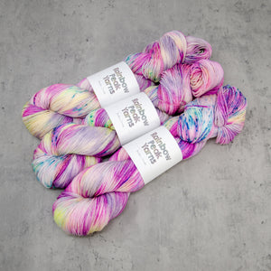 Roseate - Hand Dyed Super Sock, Fingering Weight 75/25 Merino Nylon Yarn, UV Reactive Pink Cream Multi Speckled, 463 Yards (423 Meters)